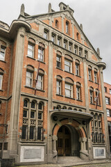 Fototapeta premium Fragments of complex of buildings of Hotel de Ville (town hall) Lille. Town hall is reminiscent of Flemish architecture with their typical triangular gables and red bricks. Lille, Flanders, France.