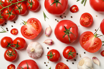 Composition with tomatoes and ingredients on white background, top view