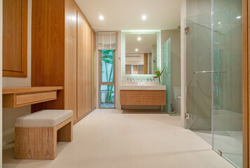Interior design of bathroom in luxury villa feature separate shower with toilet, temper glass, sink, basin, dressing table and wardrobe