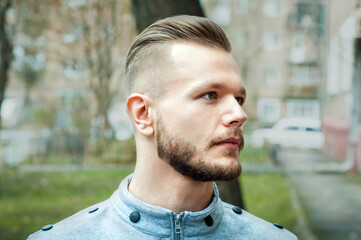 sport young man with a modern trendy fade profile haircut for barbershop