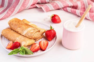 Morning breakfast. Pancakes stuffed with cottage cheese and strawberry berries.