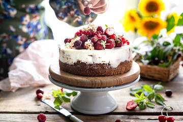 Woman's hands hold homemade berry cheesecake, selective focus. horizontal