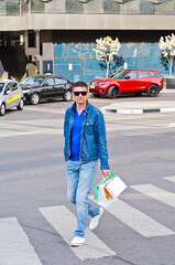 Attractive man with sunglasses and a suit case