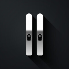 Silver Ski and sticks icon isolated on black background. Extreme sport. Skiing equipment. Winter sports icon. Long shadow style. Vector Illustration