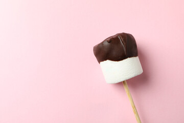 Marshmallow in chocolate on pink background. Sweet food