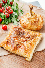 Turkish doner kebab, shawarma, roll with meat, vegetables and pita bread on a wooden background