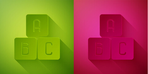Paper cut ABC blocks icon isolated on green and pink background. Alphabet cubes with letters A,B,C. Paper art style. Vector Illustration