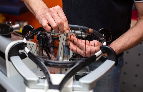 Process of stringing a tennis racket in a tennis shop, sport and leisure concept