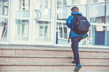 Schoolboy going to the elementary school, education concept