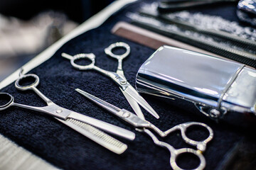 hairdressing tools on table: scissors, spinning scissors, shaver