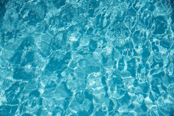 Water in swimming pool with sun reflection background