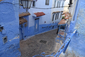 Narrow alleys with entrance doors to  houses in the blue city of Chefchaouen, Morocco