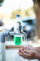 Close-up Children washing hands in a sink with nature background