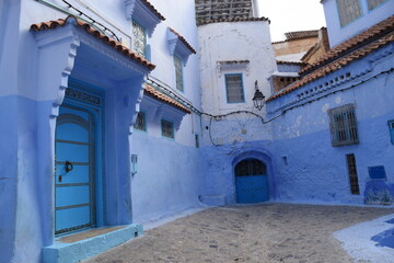 Fototapeta na wymiar Blue painted doors in the city of Chefchaouen, Morocco