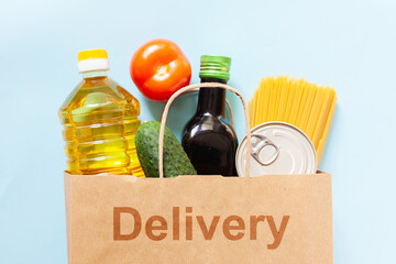 Delivery box with various products. Food set in a box on blue background. Free space for text copy space