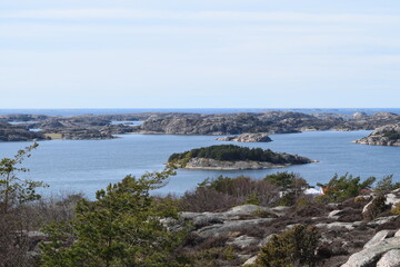 Fototapeta na wymiar Lake with a small island next to the sea on a mountain in Fjällbacka, Sweden