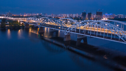 aerial night city view, luminous buildings and bridge. Drone shot.