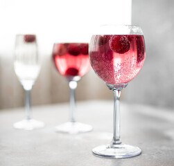 pink lemonade with cherries in a tall glass