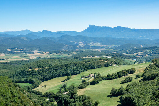 Panoramic view of the green tableland between cities of Valence and Crest in Drome region with Vercors mountains on a background.