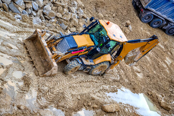 Yellow bulldozer in loam soil at Industrial construction site