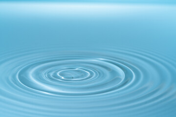 Waves on the surface of the water from a collision. Drop of water drop to the surface.