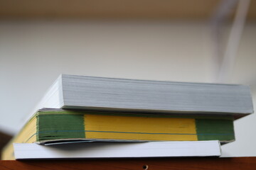 Books, Thick heavy books with white paper and hard cover, good binding, perfect binding, large number of pages, huge page booklet on table