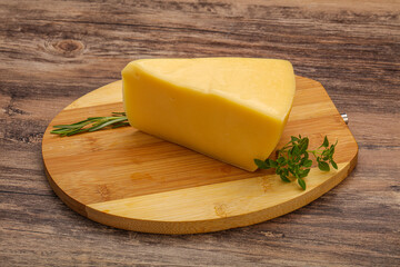 Hard cheese piece served rosemary
