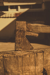 rusty ax stuck in a dry log on a sunny day