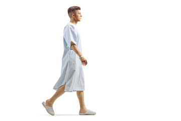 Young male patient in a hospital gown walking