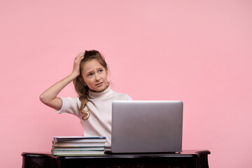 A blonde girl in a white shirt and jeans is thinking about something complicated