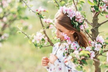 portrait of a beautiful girl in a spring garden. Flowers in your hair