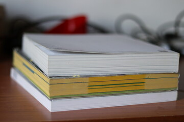 Books, Thick heavy books with white paper and hard cover, good binding, perfect binding, large number of pages, huge page booklet on table
