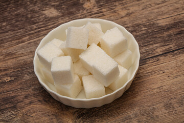 Refined white sugar cubs in the bowl