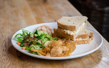 Egg sandwich with salad and crisps