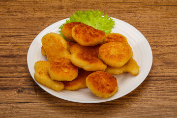 Fried chicken nuggets served salad leaves