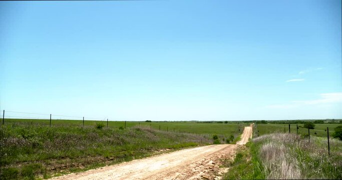 country dirt road to horizon ranch on the prairie countryside