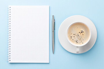Office workplace desk table with notepad and coffee
