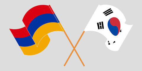 Crossed and waving flags of Armenia and South Korea