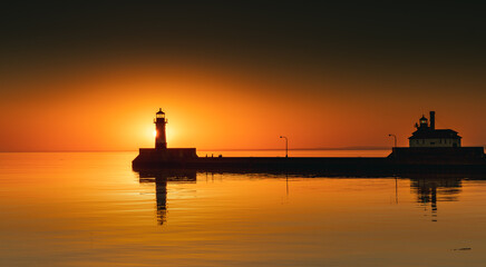 Sunrise over Horizon hiding behind the lighthouse - 355005325