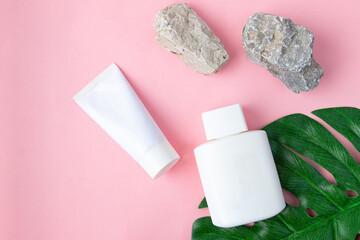 White packaging and tube for cream on a pink pastel background. Spa care concept, layout for branding.