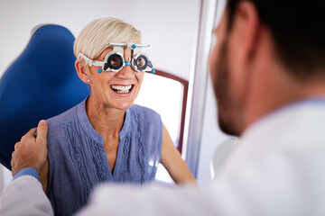 Senior woman taking an eyesight test examination at an optician clinic
