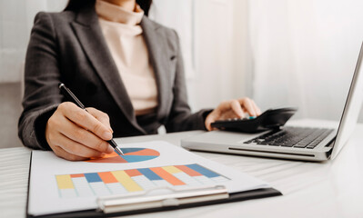 businesswoman hand using smart phone,tablet payments and holding credit card online shopping,omni channel,digital tablet docking keyboard computer at office in sun light