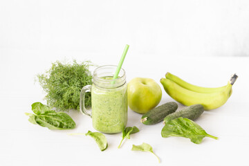 Mixed green smoothie with ingredients
