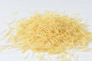 Short pasta spaghetti angel hair displayed in containers on white background