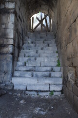 heavily destroyed and barricaded door of a ruin of Umm Qais, Jordan