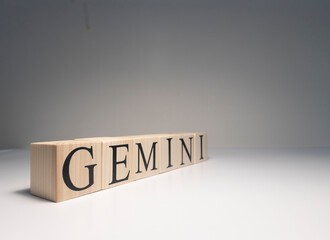 Gemini word on wooden cubes on white background.