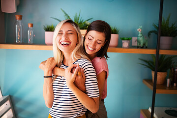 Cheerful lesbians embrace passioantely and have fun together - obrazy, fototapety, plakaty