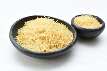 Short pasta spaghetti angel hair displayed in containers on white background