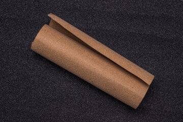 Sandpaper roll on abrasive surface, top view