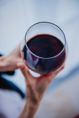 red wine in a glass in women's hands